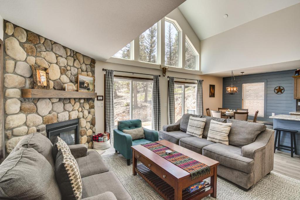 a living room with couches and a stone wall at Fairplay Family Cabin on 2 and Acres! 25-0283 in Fairplay