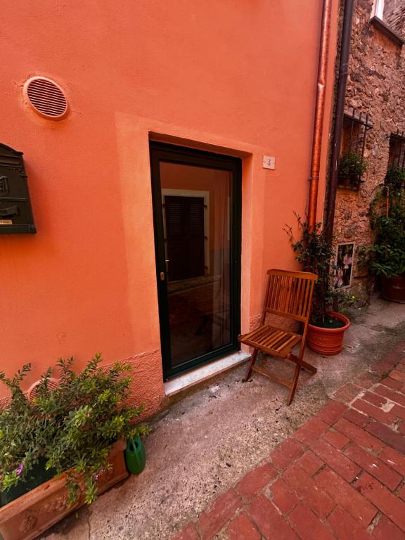 a wooden bench sitting in front of a building at Bia Apartments pt in Monte Marcello