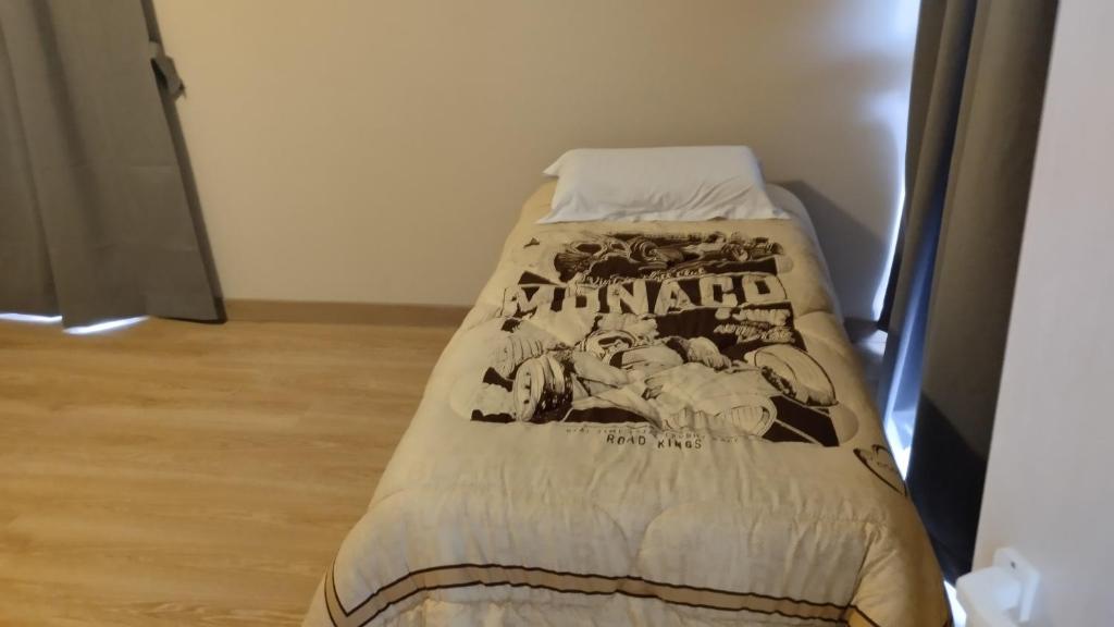 a bed with a blanket on it in a room at LOS NARANJOS in Reconquista