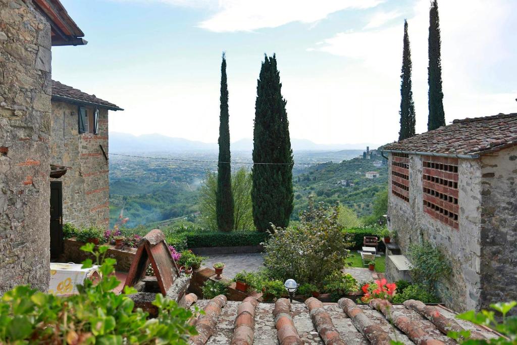 a view from the garden of a house with trees at Villa With Views Over Lucca Hills in Matraia