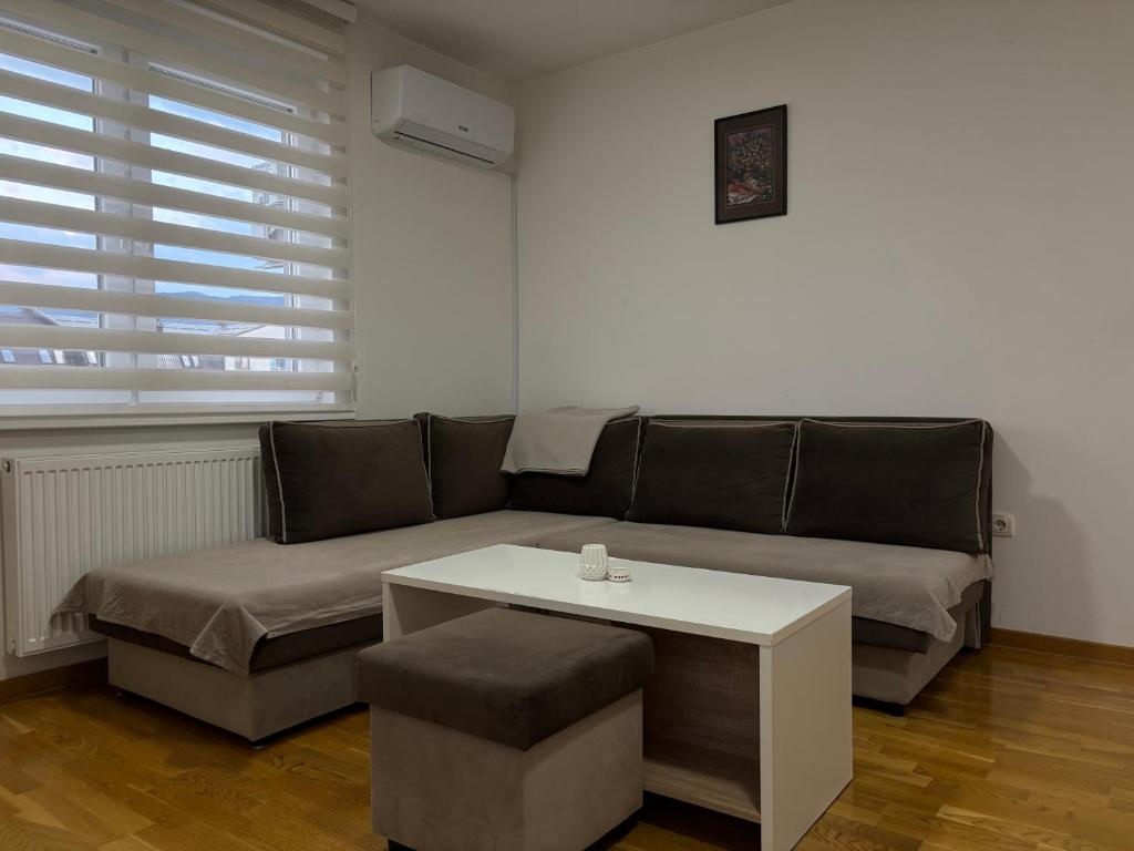 a living room with a couch and a table at Apartman Pale - Biljana in Pale