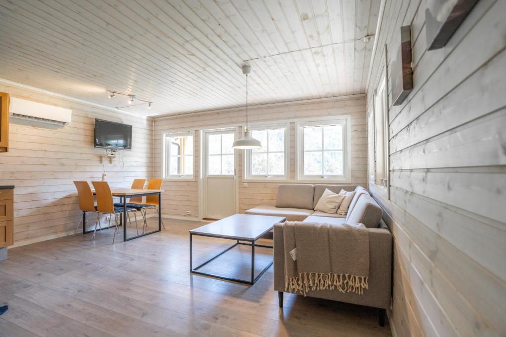a living room with a couch and a table at Family Cabins in Fjæra