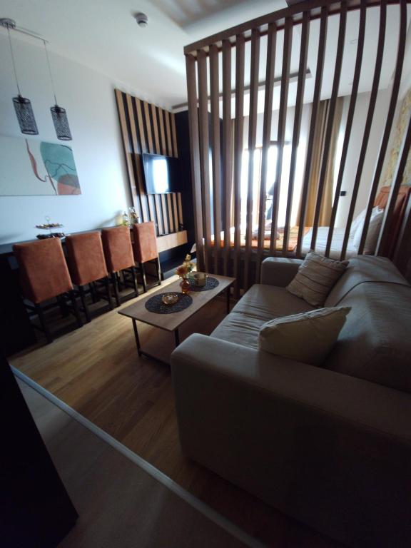 a living room with a couch and a table at Una LUX N85 in Kopaonik