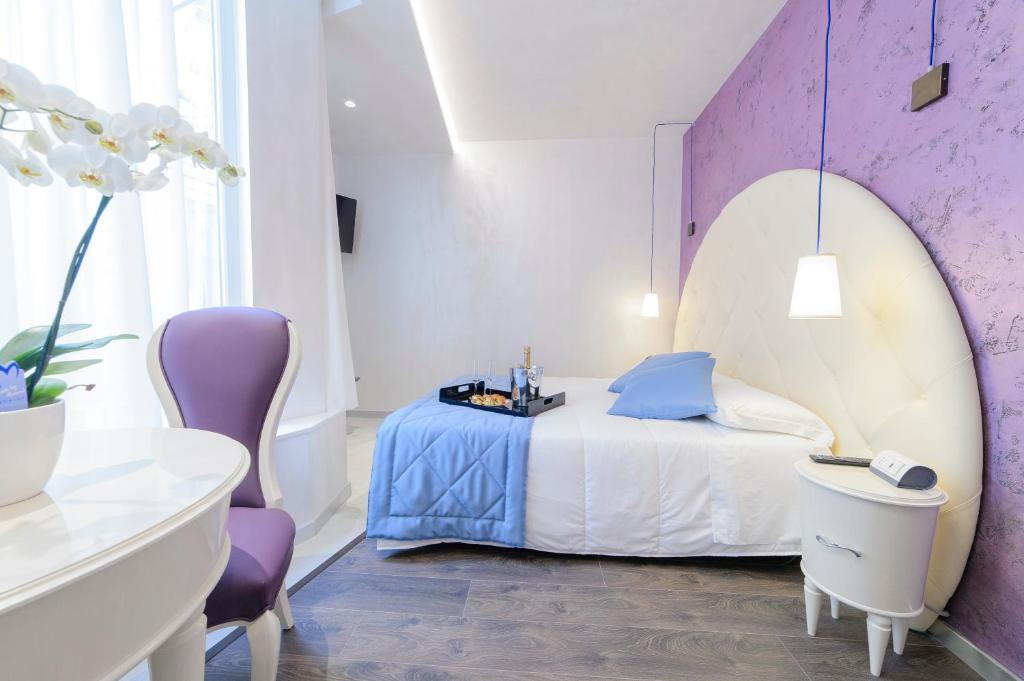 Postel nebo postele na pokoji v ubytování Hotel Vespasiano