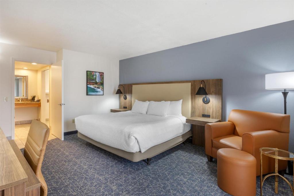 a hotel room with a bed and a chair at Best Western Plus A Wayfarer's Inn & Suites in Kingman