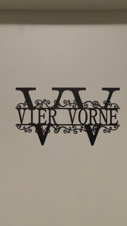 a sign on a wall that reads vier vienne at Über den Dächern im Vier Vorne in Gütersloh