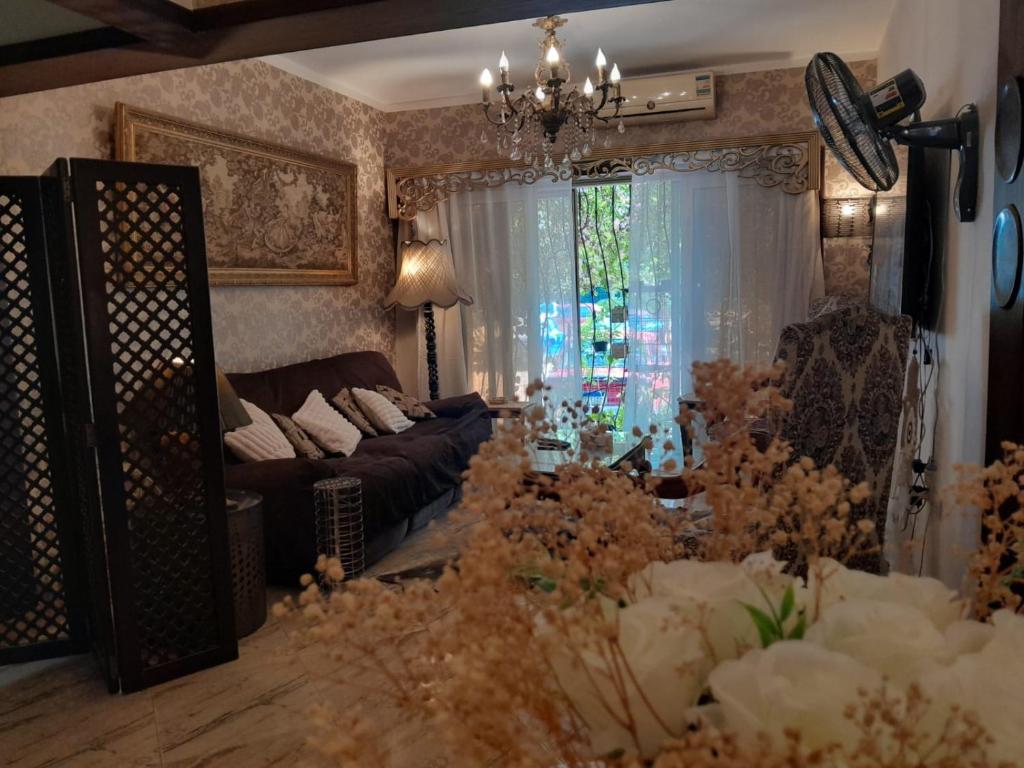 a living room with a couch and a window at Quiet Living in Cairo