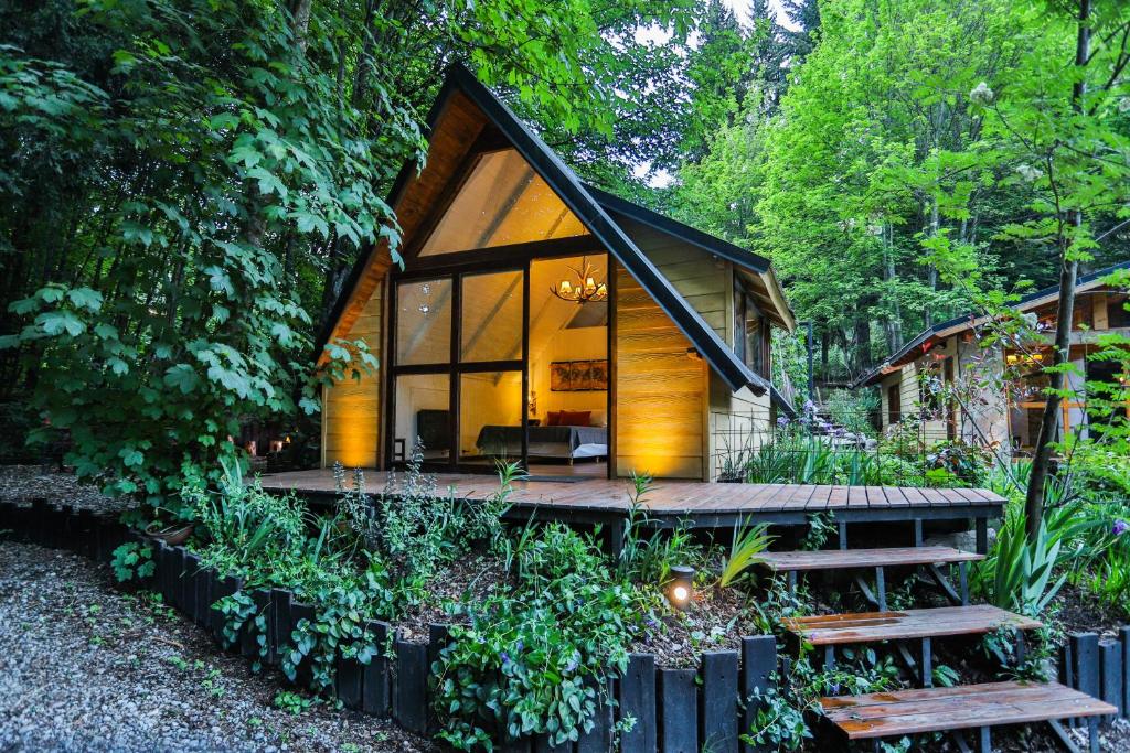 a cabin in the woods with a large window at Complejo de Cabañas Ideales para parejas in San Carlos de Bariloche