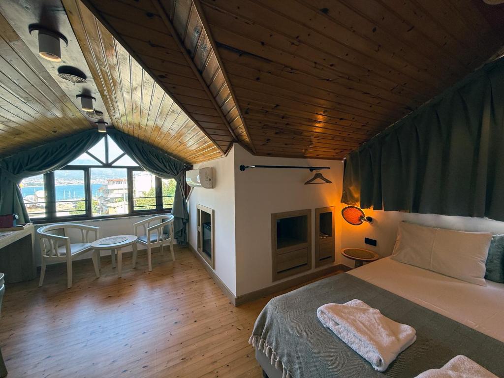 a bedroom with a bed and a fireplace in a room at Casa Vagabundo Boutique Hotel - Adults Only in Alanya