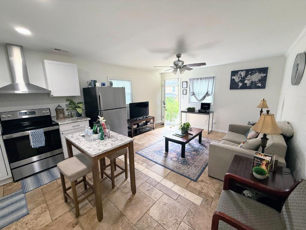 a living room with a couch and a kitchen with a table at Renovated 2 Bedroom in Durham! Superhost! in Durham