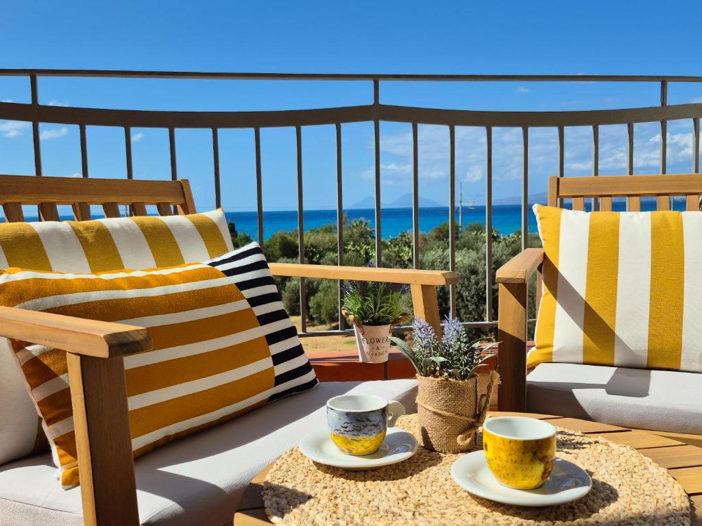 a patio with two chairs and two cups on a table at Casa Vacanze-Halivita in Piraino