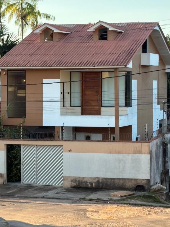a house with a red roof at Linda casa confortável em Manaus in Manaus