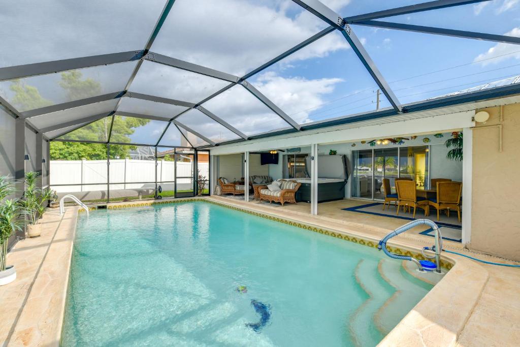 an indoor swimming pool with a glass roof at Fish, Swim and Relax Canal-Front Port Charlotte Gem in Port Charlotte