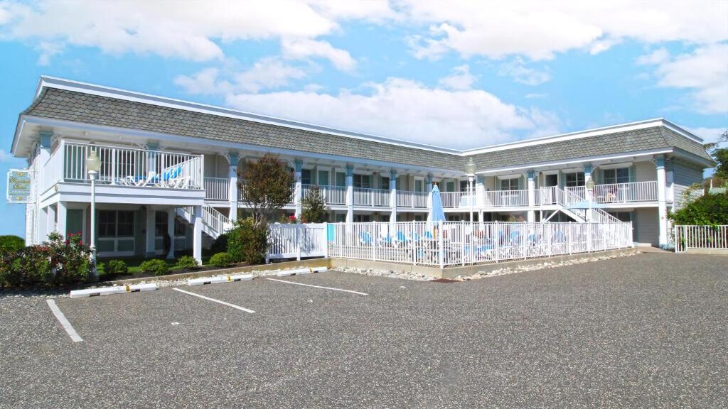 a building with a lot of chairs in a parking lot at Condo At The Cove Unit 5 in Cape May