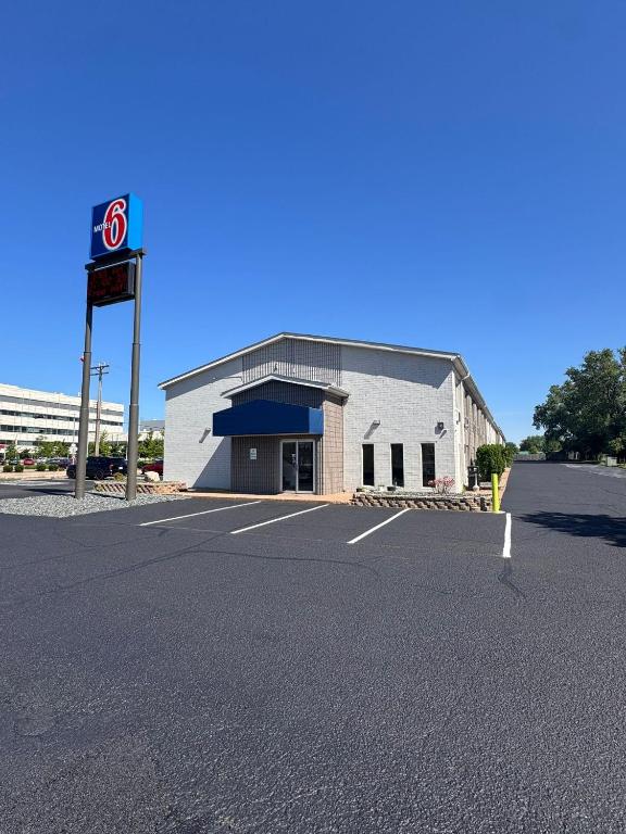 an empty parking lot in front of a gas station at Motel 6-Eau Claire, WI in Eau Claire