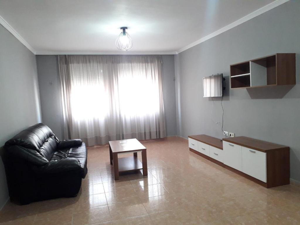 a living room with a couch and a coffee table at Apartamento Turístico Céntrico Galper in Melilla