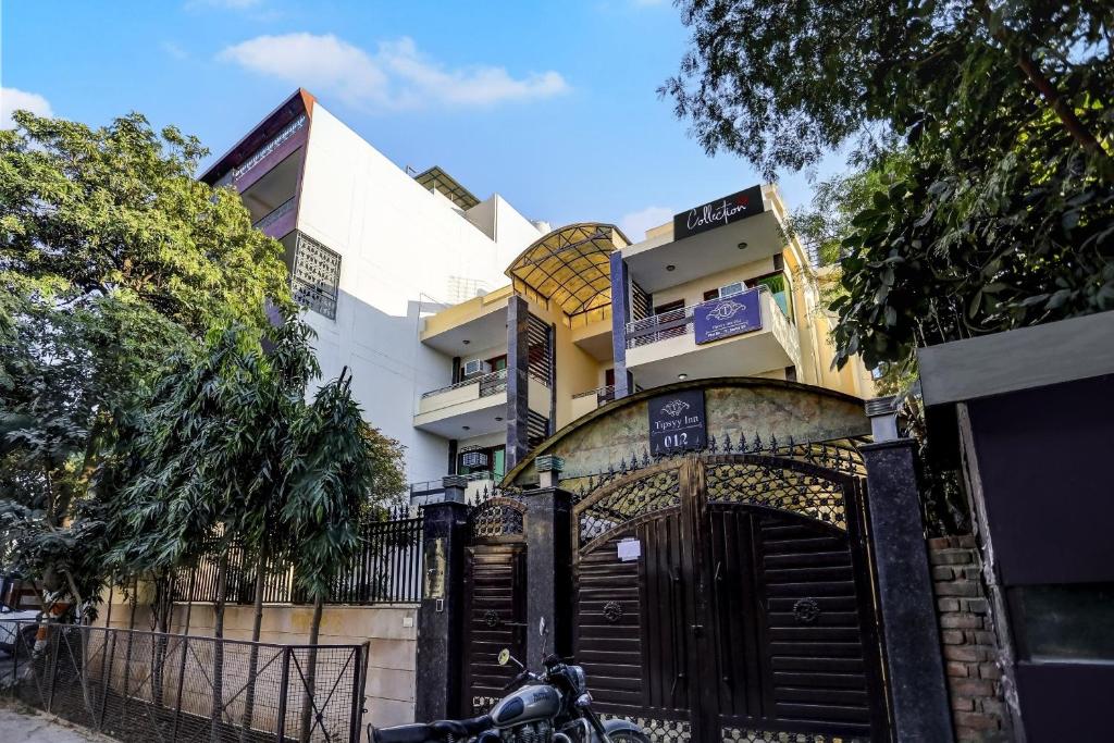 a motorcycle parked in front of a building at Hotel O Uk House Residency in Gurgaon