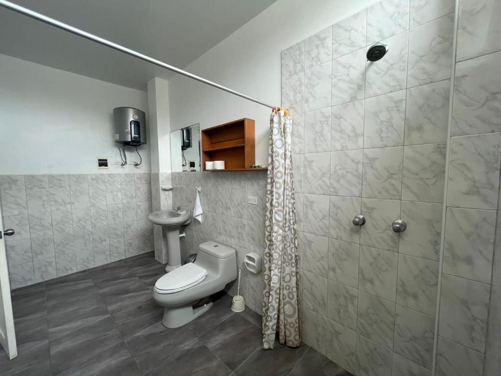 un baño con inodoro y ducha en Residencia Madona del Mar - Casa Frente al Mar con Piscina, en Zorritos