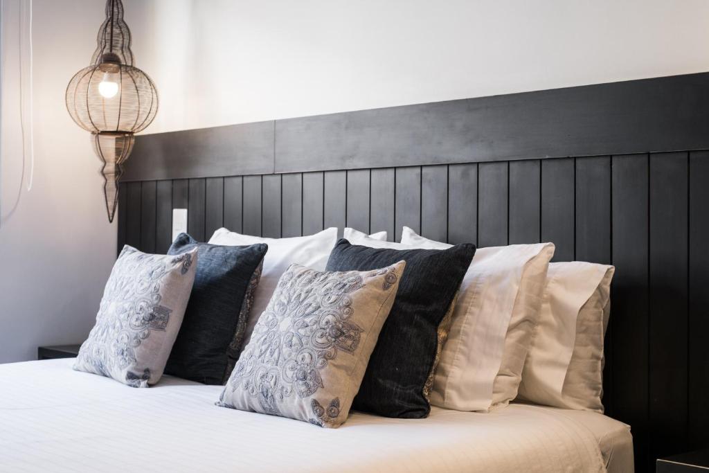 a bedroom with a black headboard and pillows on a bed at Apart Hotel B in Santiago