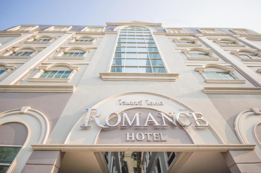 a hotel sign on the side of a building at Romance Hotel Srinakarin in Bangkok