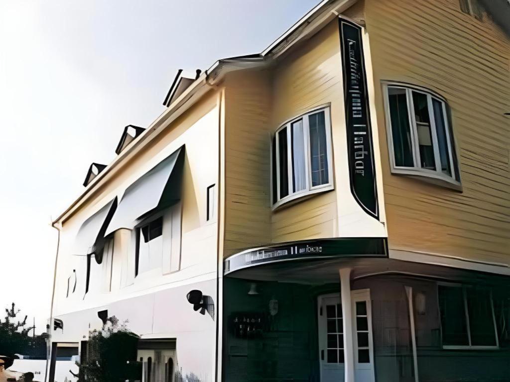 a building with a sign on the front of it at Petit Hotel Kashikojima Harbor in Shima