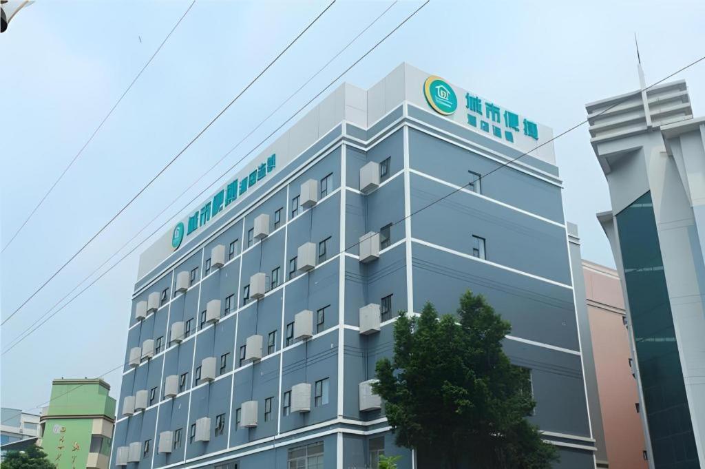 a building with a sign on the side of it at City Comfort Inn Guangzhou Tianhe District Tangxia Exhibition Center in Guangzhou