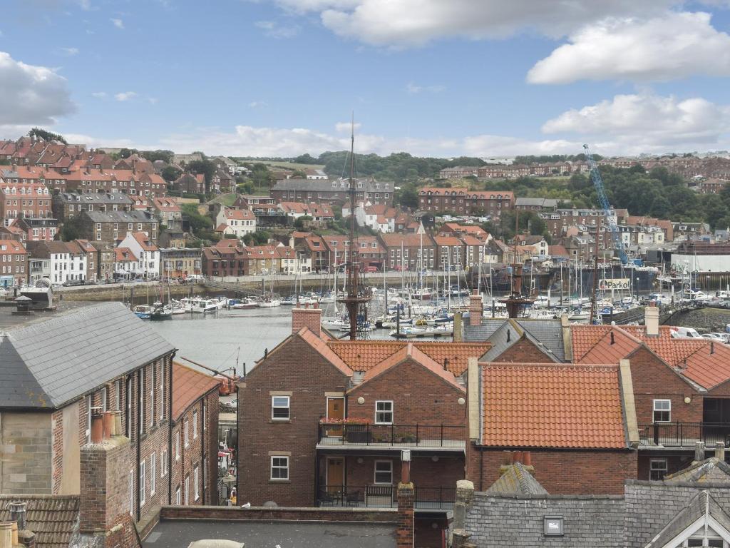 a view of a city with houses and a harbor at Coast Apartment in Whitby
