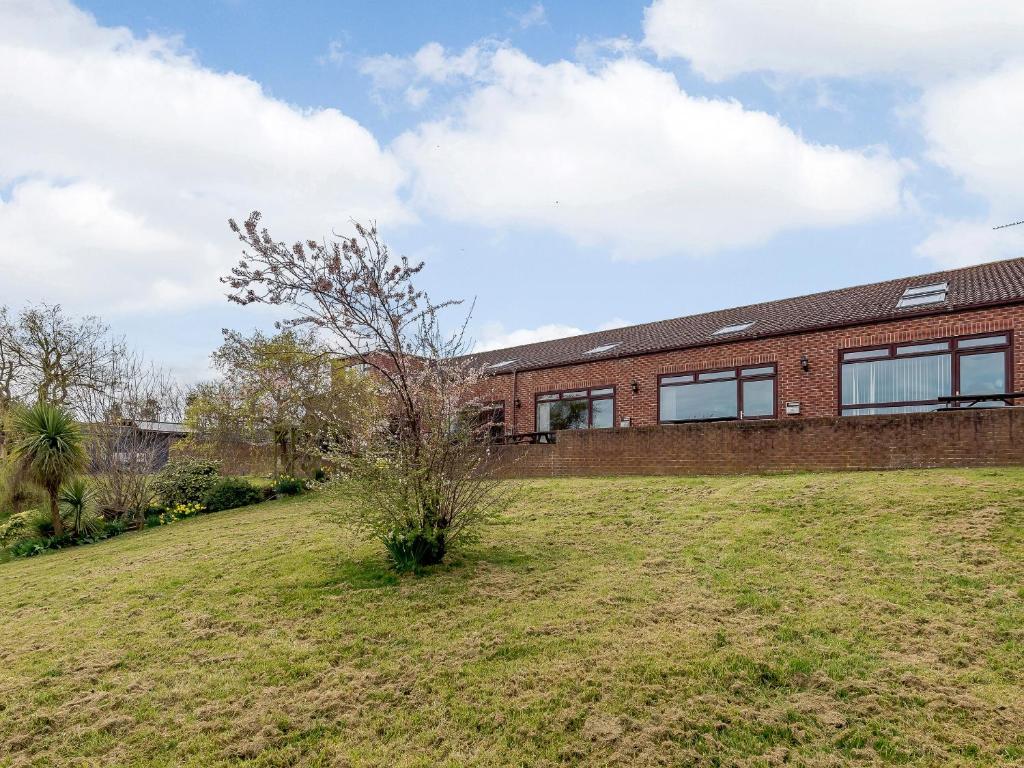 a brick house with a tree in a field at Cottage 6 - Uk38217 in Ashby cum Fenby