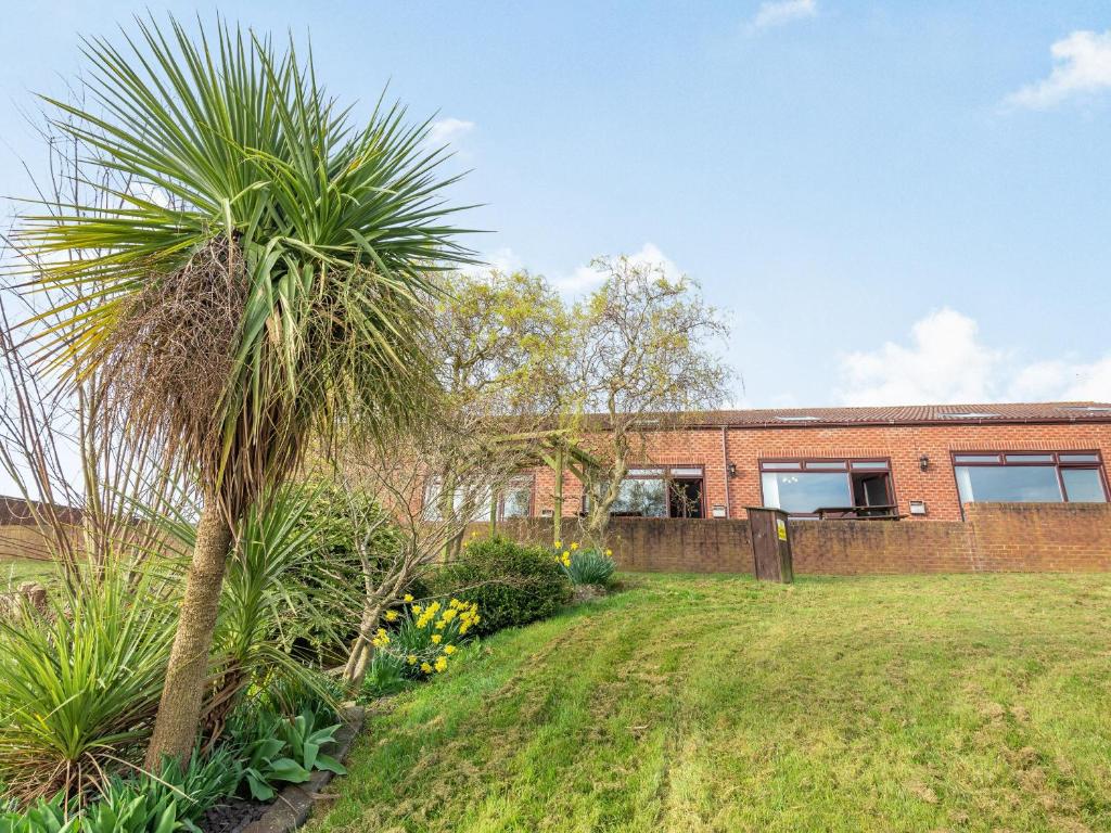 a palm tree in front of a brick house at Cottage 9 - Uk38220 in Ashby cum Fenby