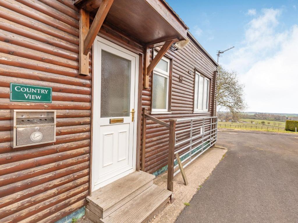 a wooden cabin with a door on the side of it at Country View - Uk38223 in Ashby cum Fenby