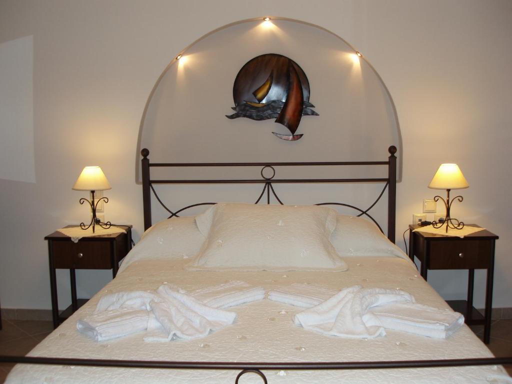 a bed with a glass dome over it with two lamps at Anastasia Studios in Avlemonas