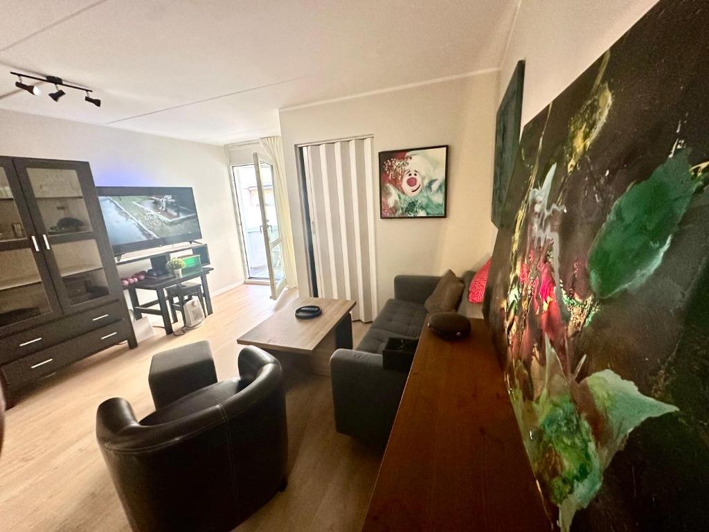 a living room with a couch and a table at Exclusive Central-Home in Central Oslo- for five people in Oslo
