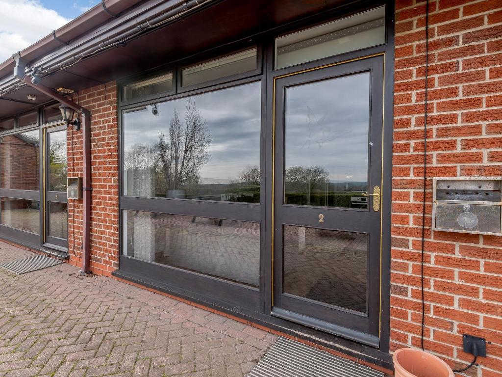 a brick building with large glass windows on it at Cottage 2 - Uk38222 in Ashby cum Fenby