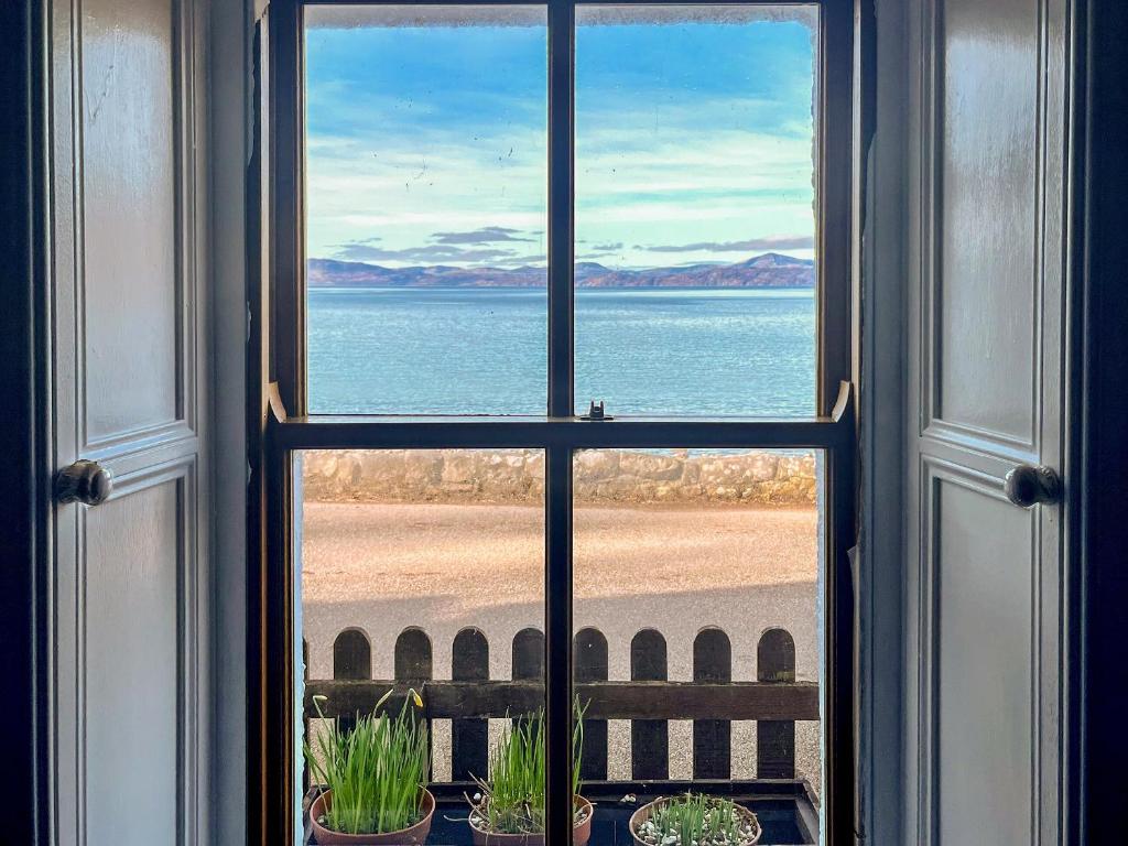 a view of the ocean from a window at The Fisherman's Cottage in Applecross