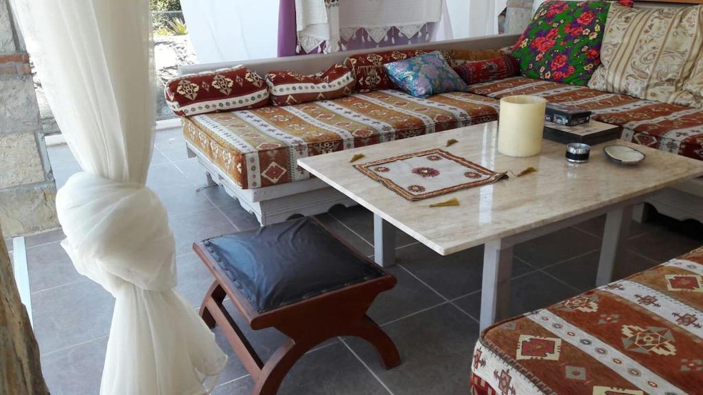 a living room with a couch and a table at Villa Selen in Bogazici
