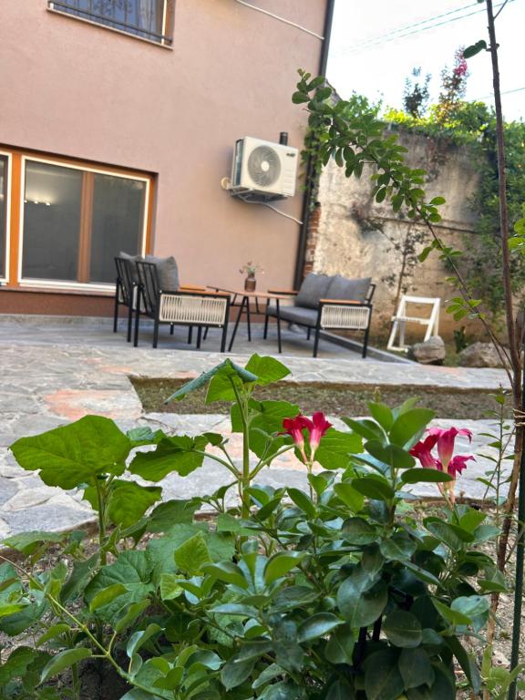 a patio with two chairs and a tv on a building at Apartman Stone Garden in Mostar
