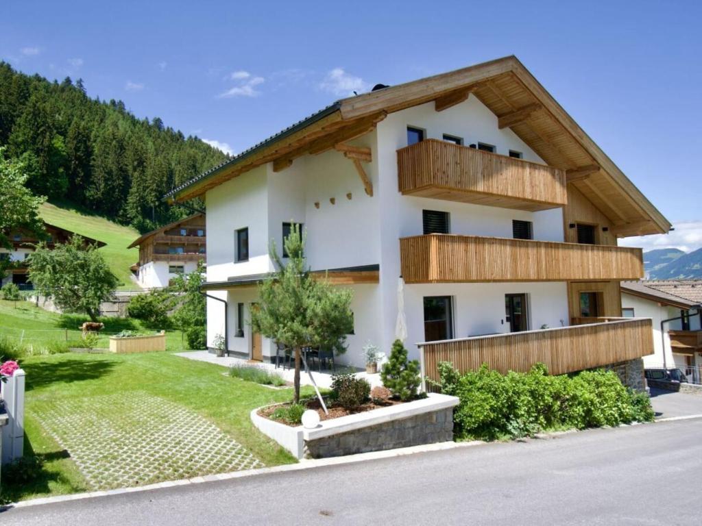 a house in the mountains with a wooden roof at Holiday apartment for 5 people in Ried im Zillertal