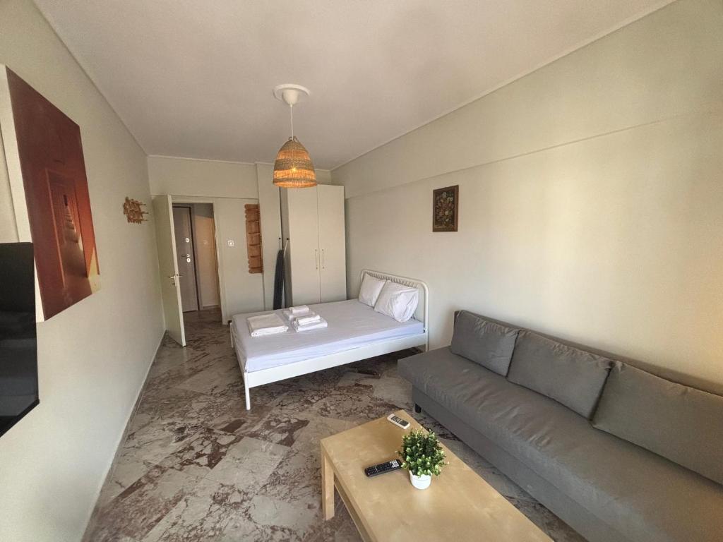 a living room with a couch and a table at Summer Holidays in Nea Kalikratia