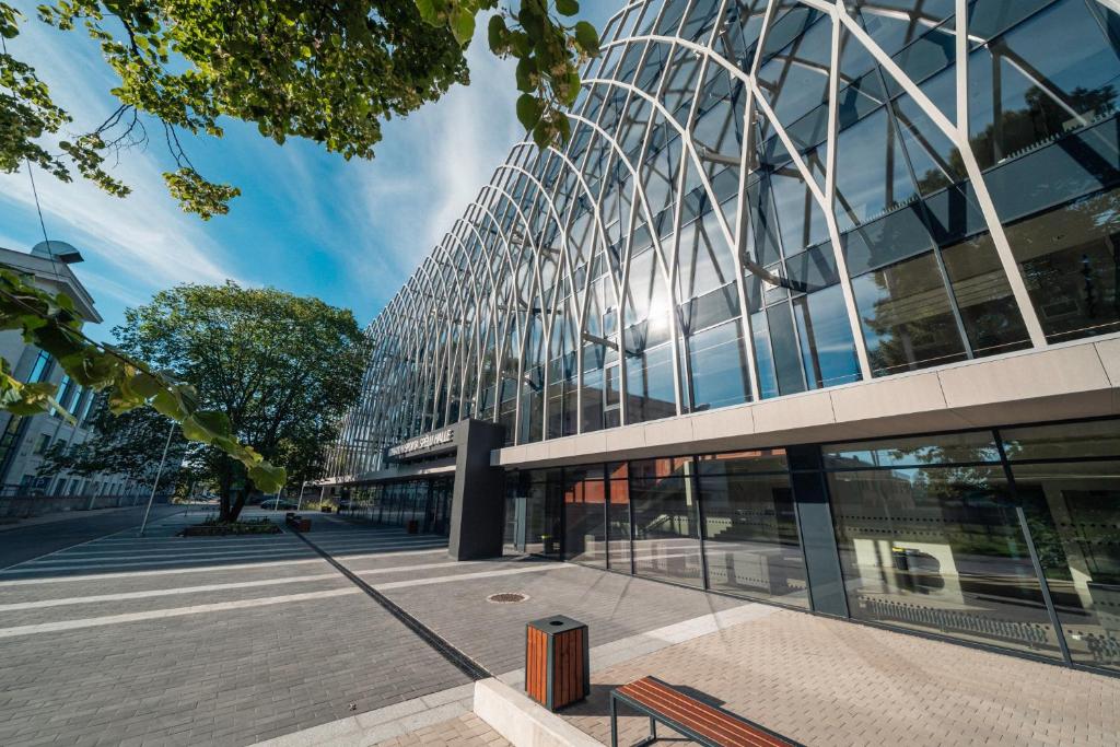 a building with a bench in front of it at Komandu Sporta Spēļu Halles viesnīca in Rīga