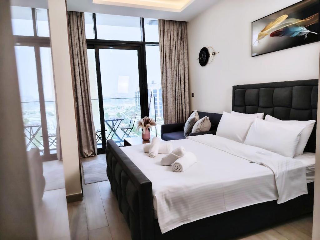 a bedroom with a large bed and a large window at Pet Free Studio Apartment Close Downtown Fast Wi-fi in Dubai