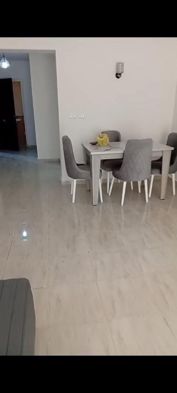 a dining room with a table and chairs at 3BR furnished apartment in Madinaty B1 شقة مفروشة 3 غرف نوم في مدينتي in Madinaty