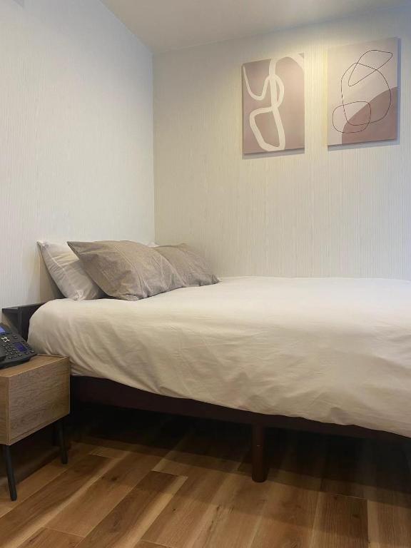 a bedroom with two beds and a wooden floor at daren stay in Tokyo