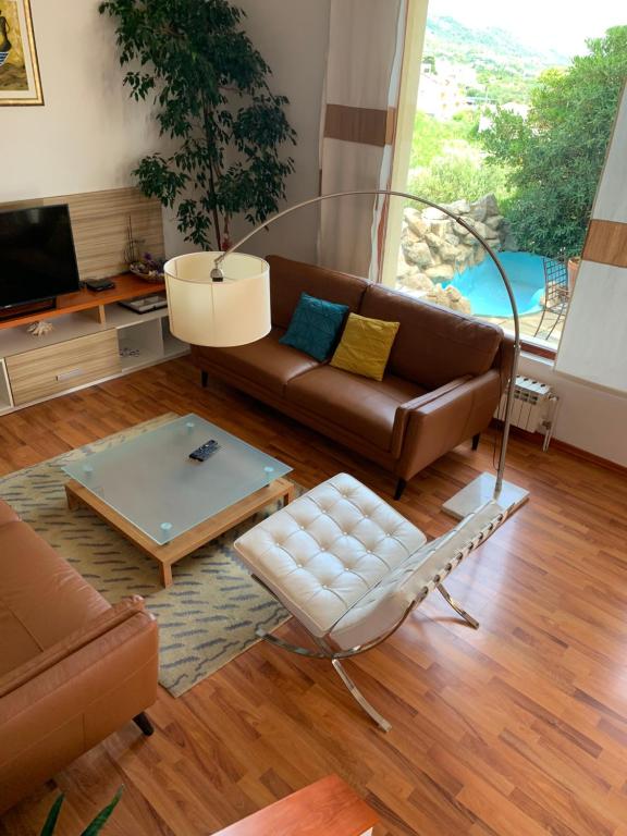 a living room with a couch and a table at Holiday Home Mirjana in Rab