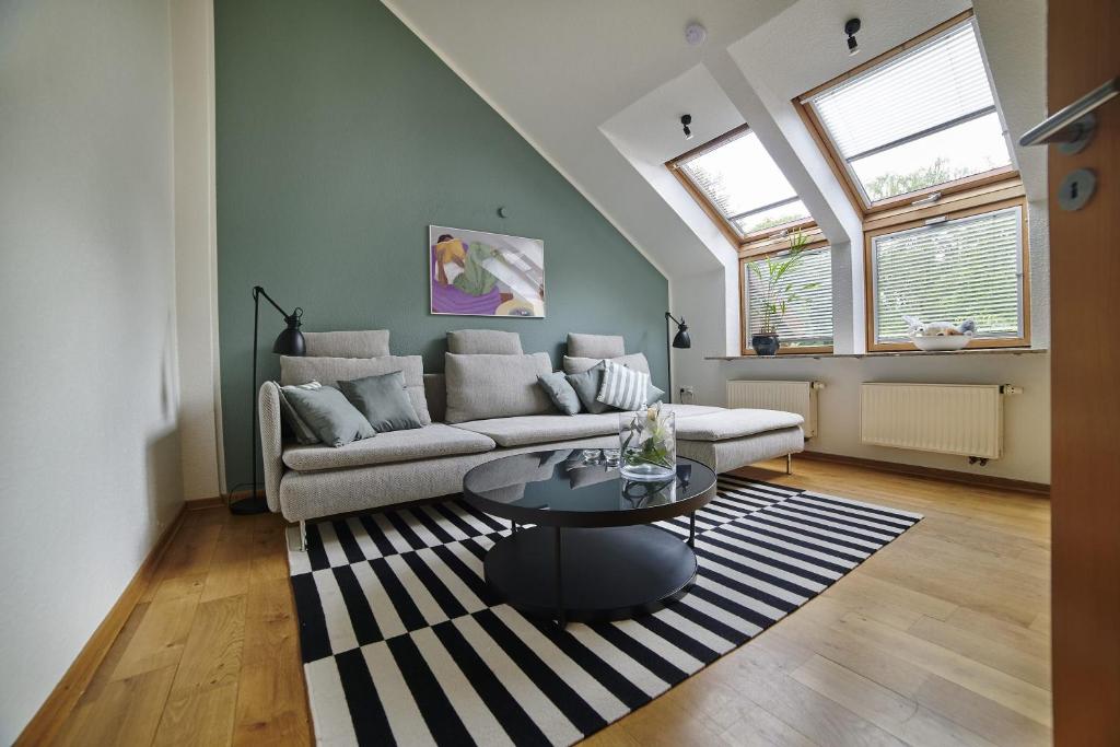 a living room with a couch and a table at Ferienwohnung Smart am Park 35670 in Uplengen