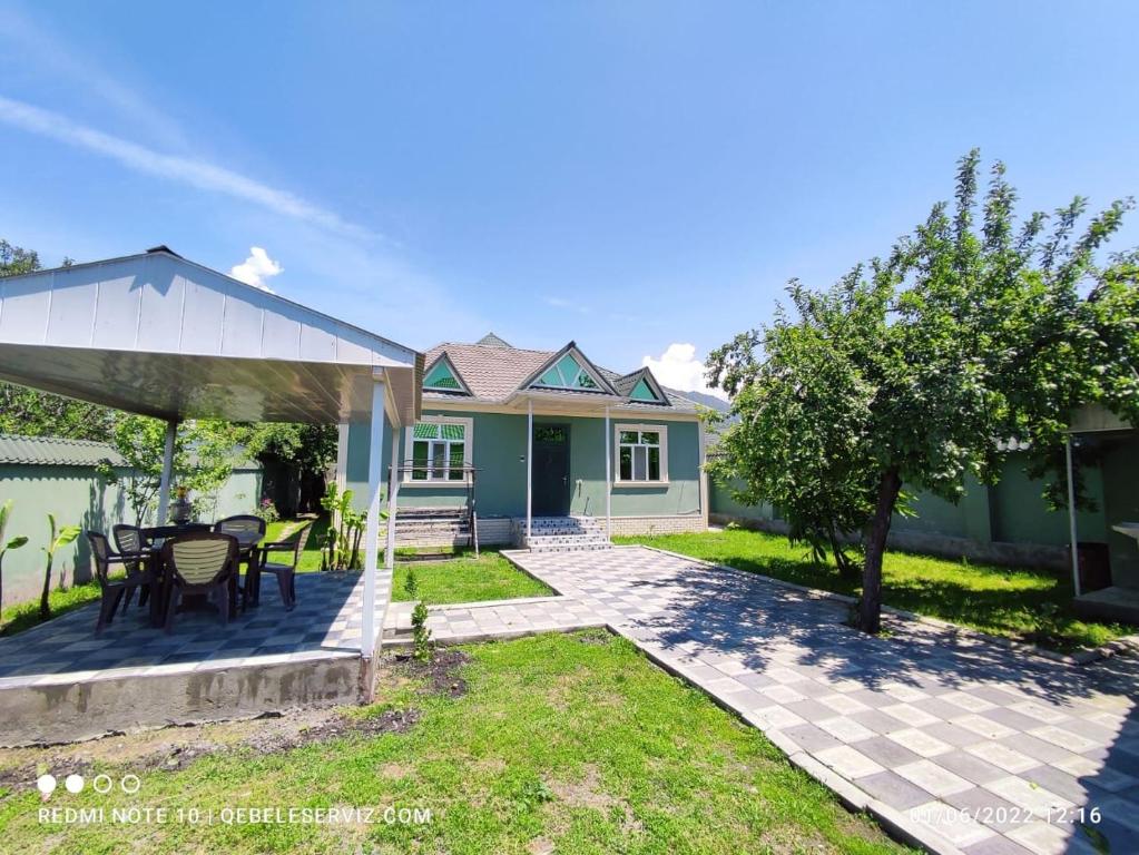 a house with a patio with a table and chairs at QQS villa with swimming pool in Gabala