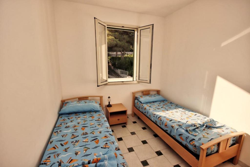 Ένα ή περισσότερα κρεβάτια σε δωμάτιο στο Appartamenti immersi nel verde