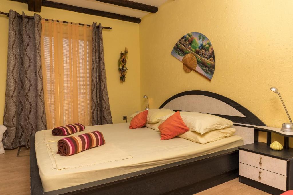 a bedroom with a bed with pillows on it at Apartman Katarina in Dramalj