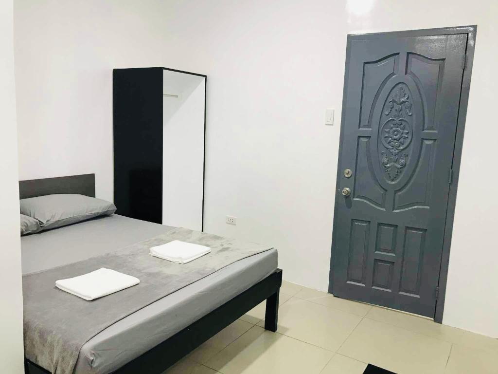 a bedroom with a door with two towels on a bed at Sea Bed's Inn in Glan