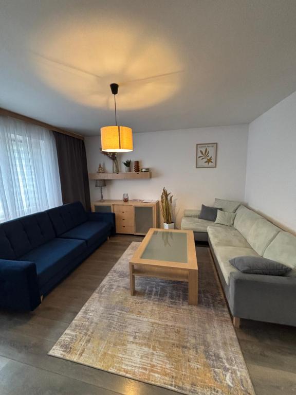 a living room with a couch and a coffee table at Krásny apartmám CENTRUM in Martin