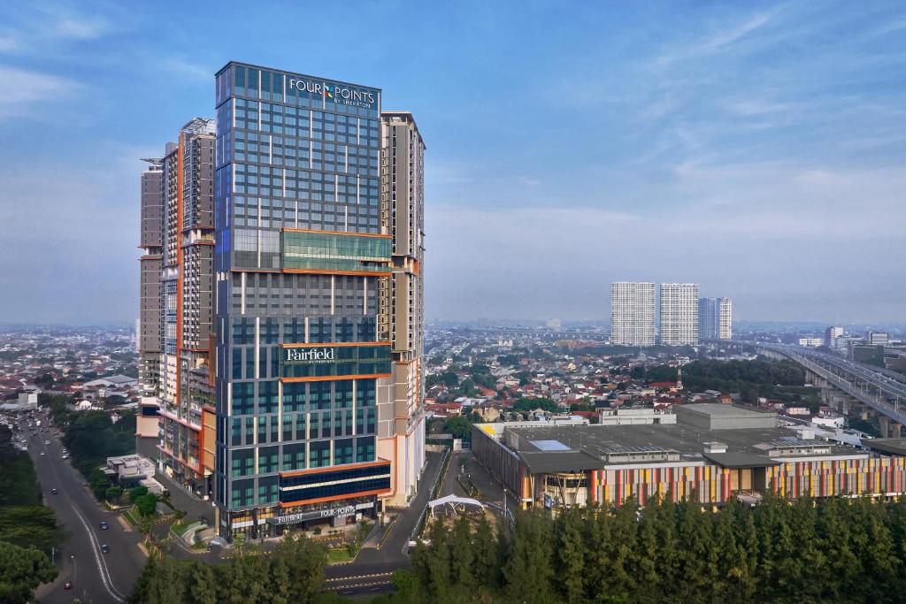 a tall building in a city with a bridge at Four Points by Sheraton Bekasi in Bekasi